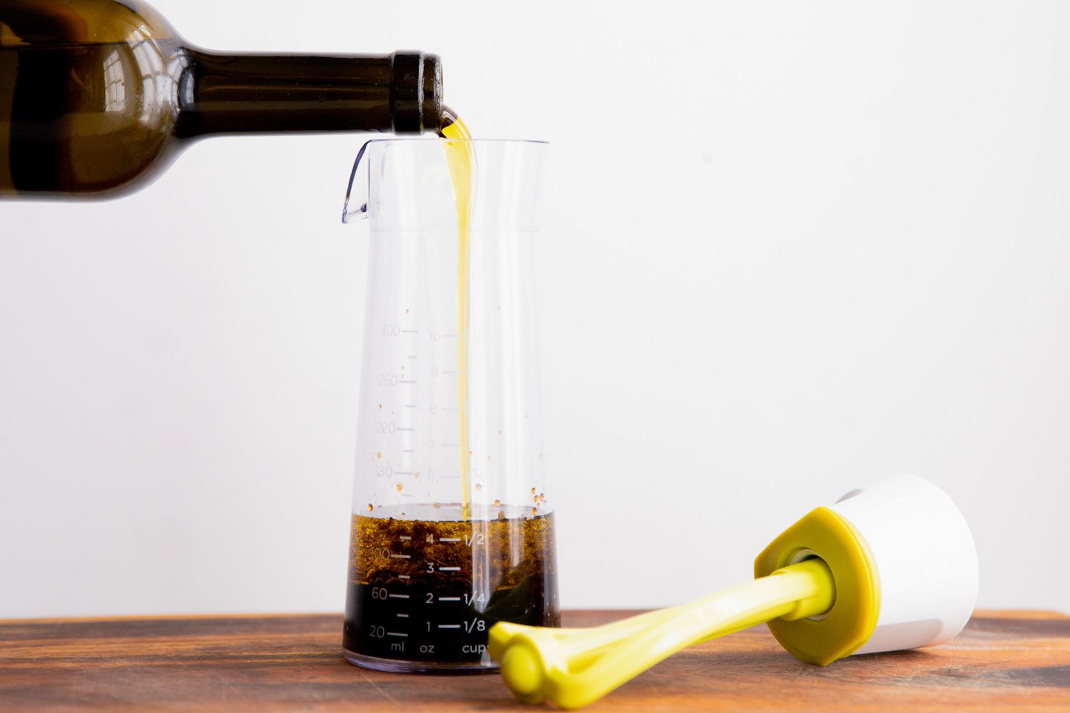 oil being poured into Emulstir Salad Dressing Mixer