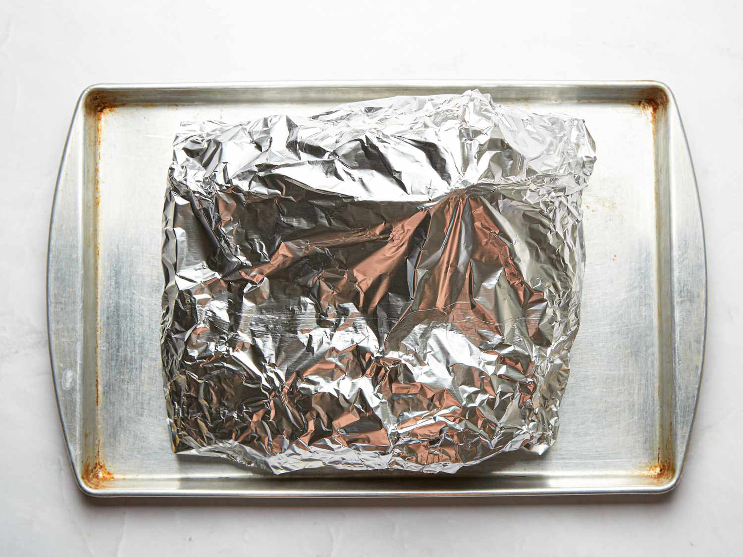 Overhead view of foil wrapped meat