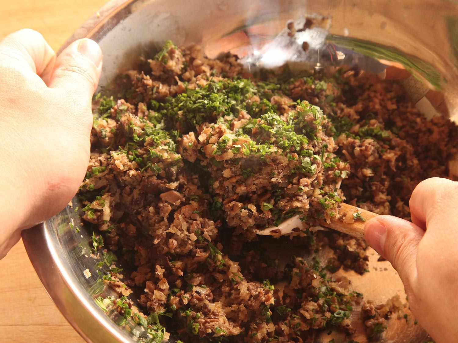 Folding parsley, tarragon, chives, and chervil into duxelles.