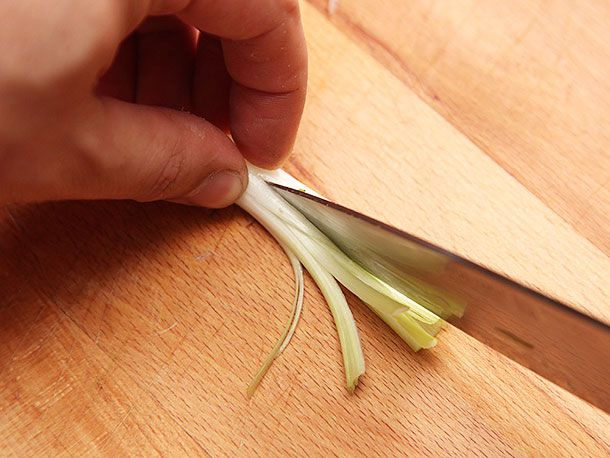 The scallion, rotated, and sliced length-wise again to create a "brush."