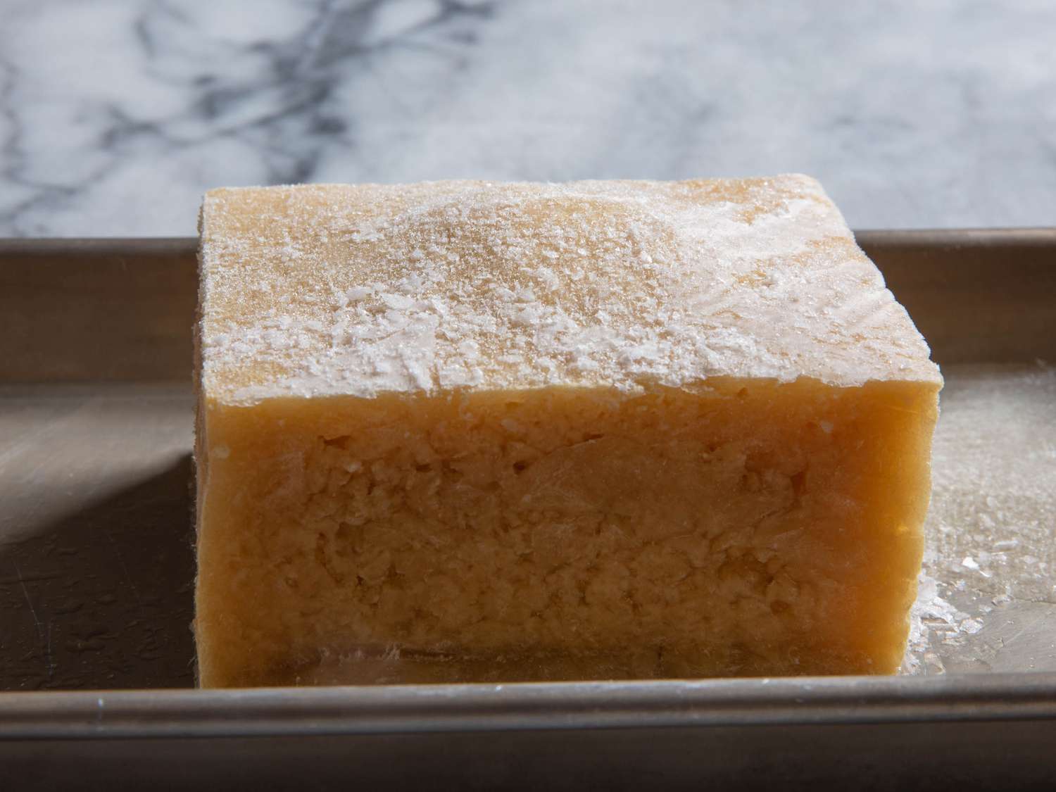 Frozen block of tofu on a sheet pan