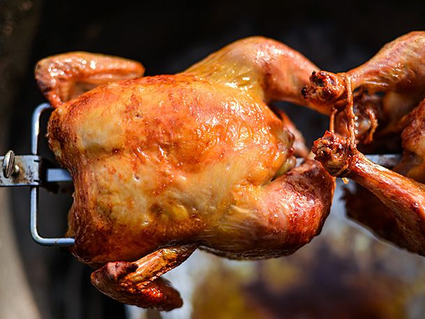 Closeup of a good chicken on the spit, ready to remove from the rotisserie and serve.