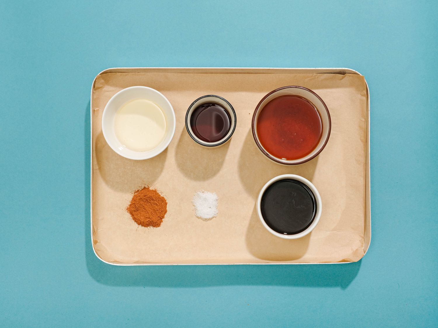 pise en place or agave, instant coffee, vanilla, salt, cinnamon, and melted coconut oil on a sheet pan