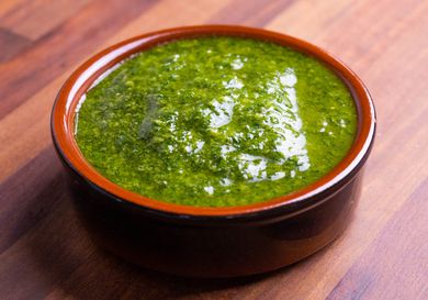 Closeup of a ramekin full of fennel frond pesto.