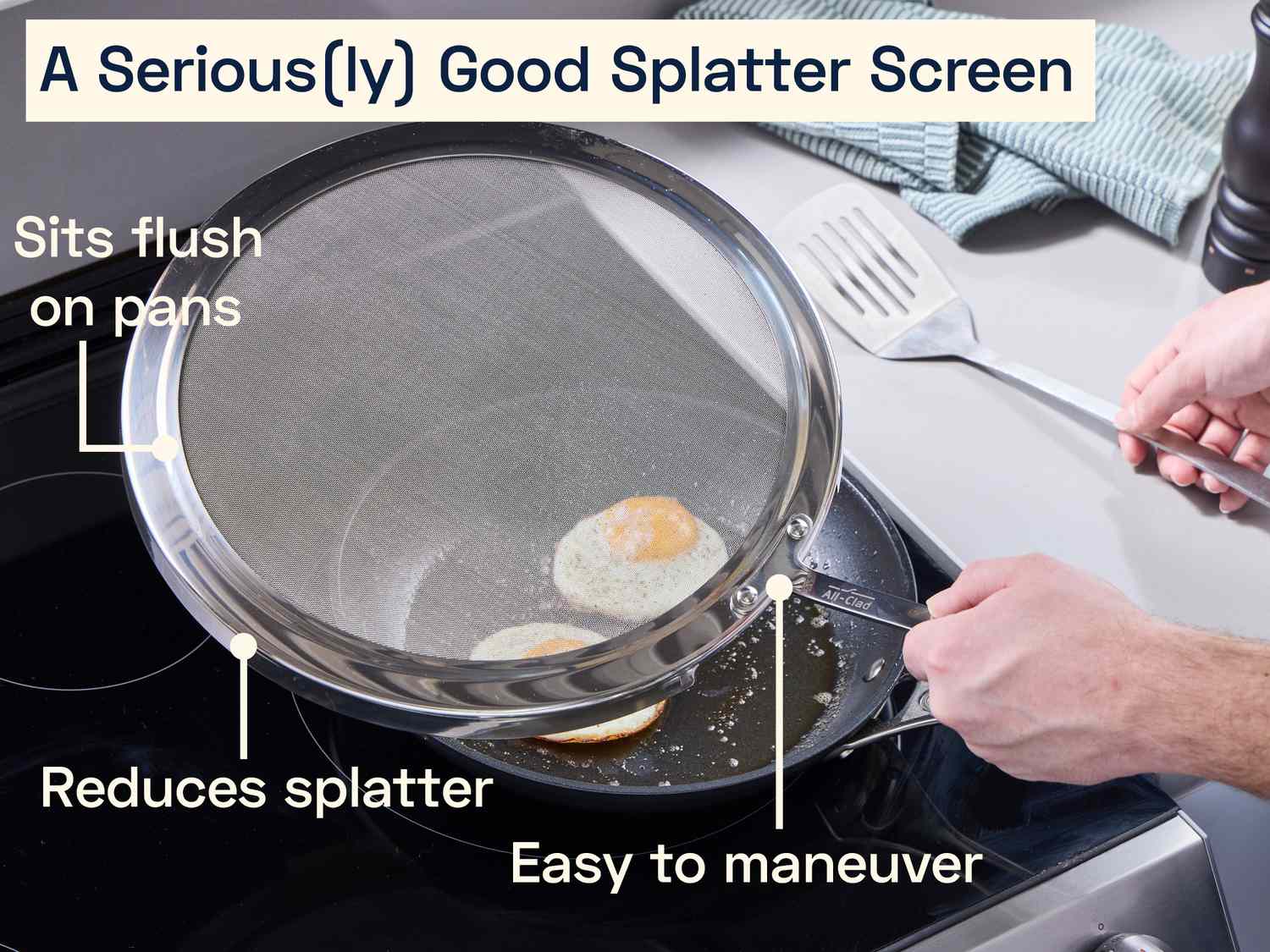 a person using a splatter screen to cover fried eggs