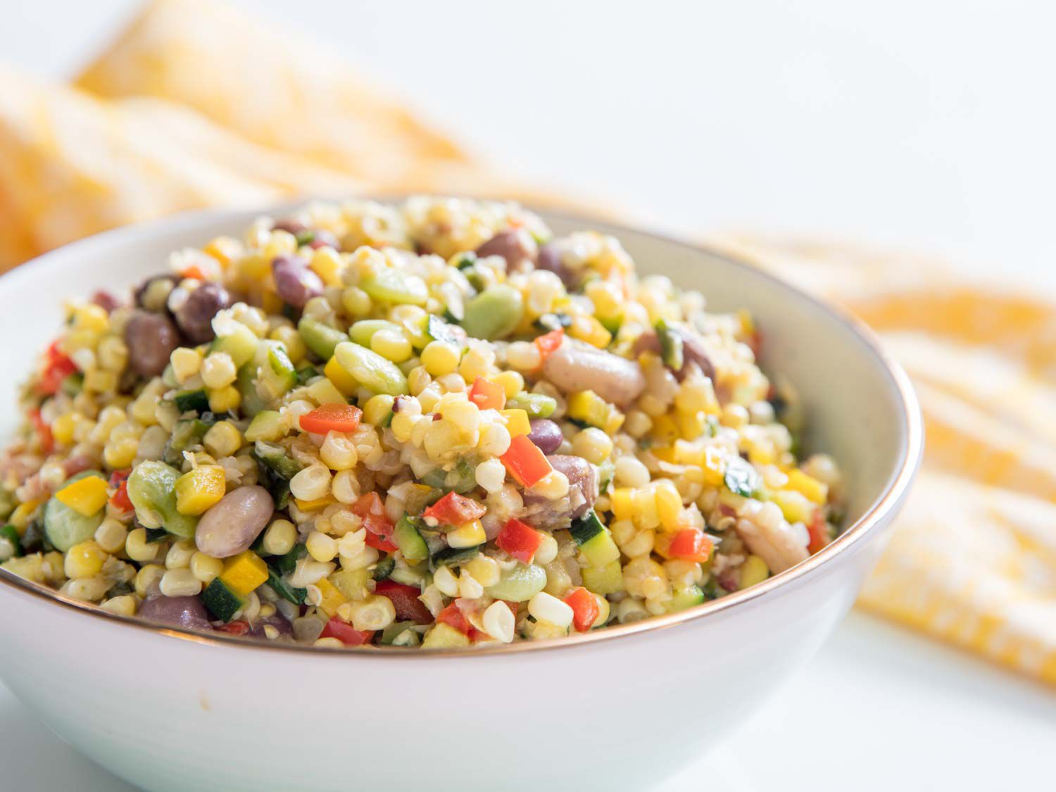 Closeup of the finished succotash, served in a deep ceramic bowl.
