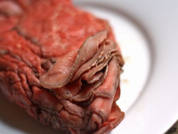 Close-up of a pile of thinly sliced roast beef.