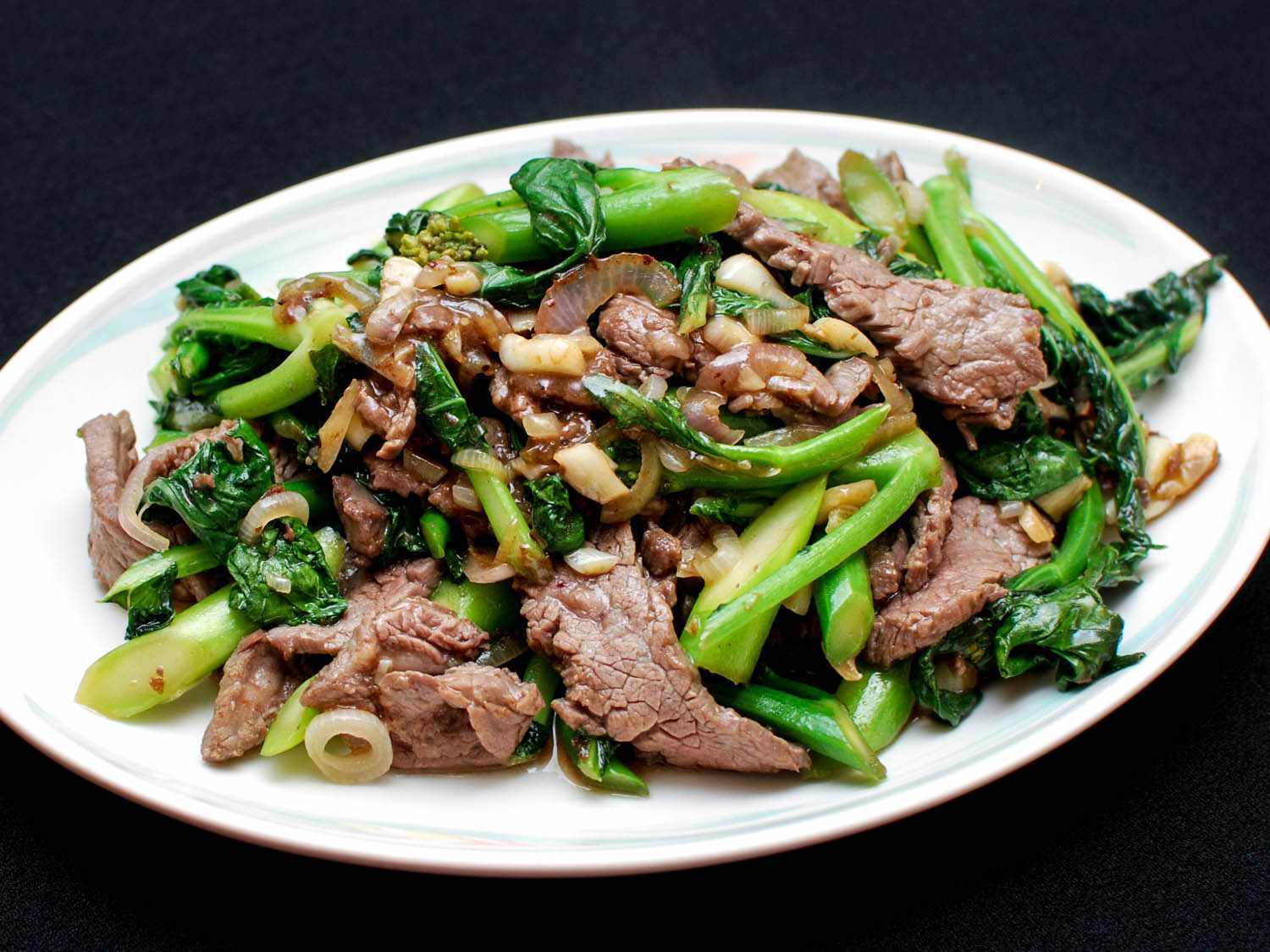 Stir-fried beef with Chinese broccoli (or gai lan) on a plate.