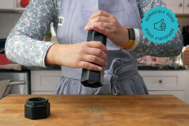 a person using the hexmill to grind pepper