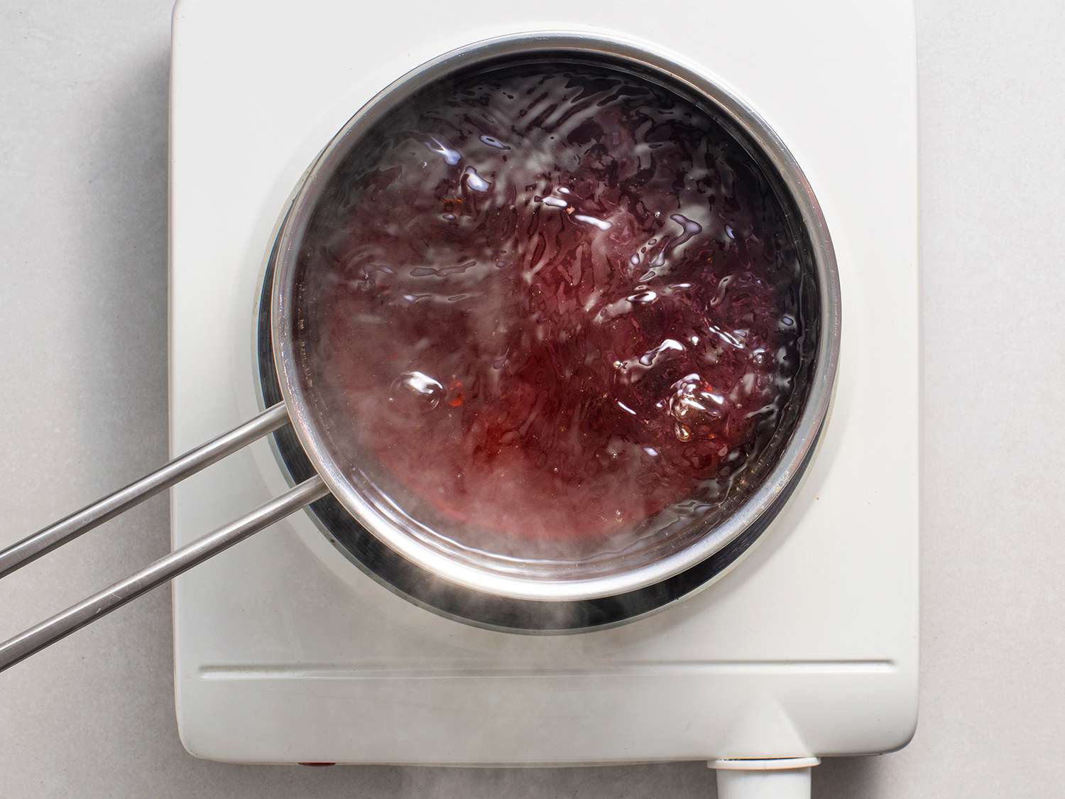 Dashi, mirin, soy sauce, and sugar boiling in a pot