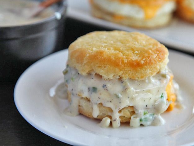 A golden brown biscuit, cut in half and filled with creamy ramp gravy.