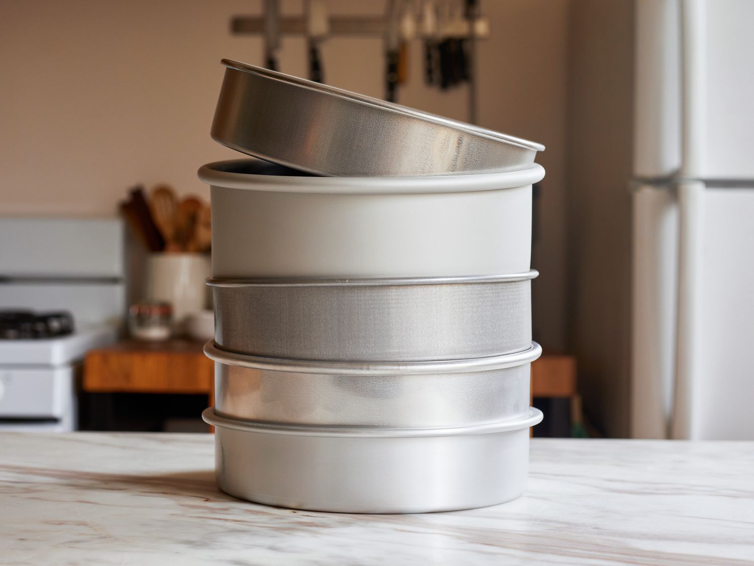 a stack of cake pans on a kitchen countertop