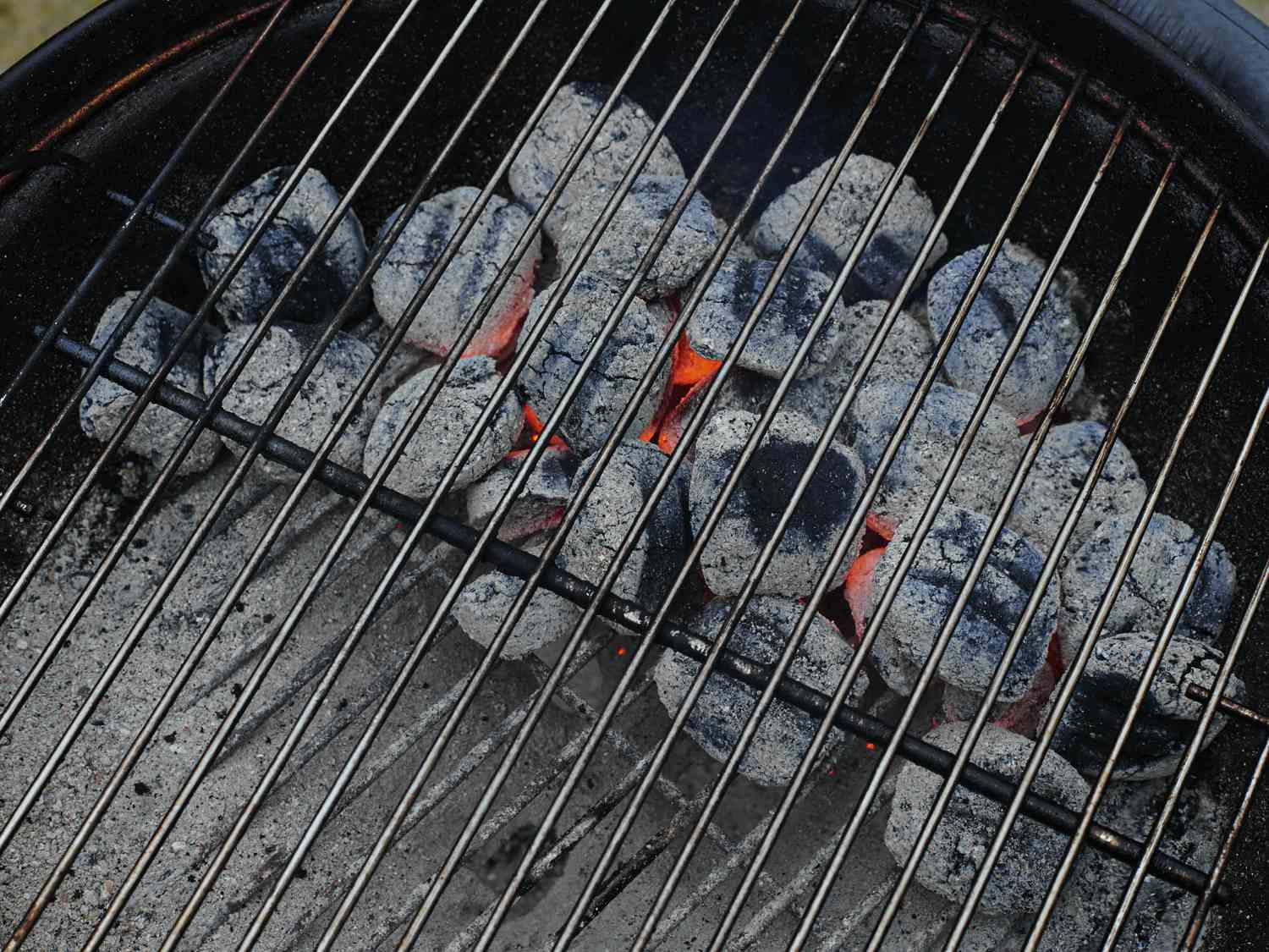 Overhead view of coals on one side of a grill