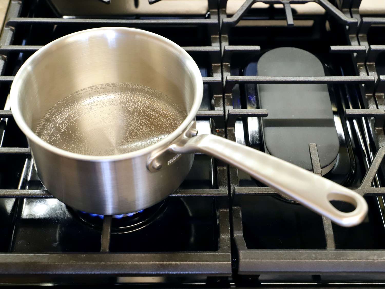 Made In Stainless Clad Saucepan on lit stovetop