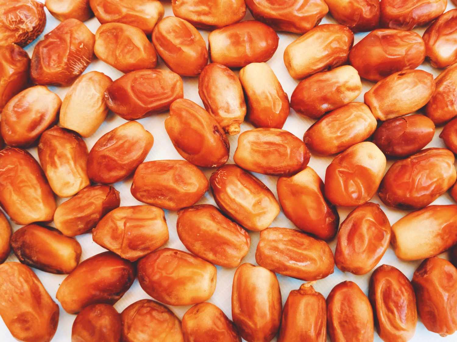 A closeup of several dates laid out in a pattern