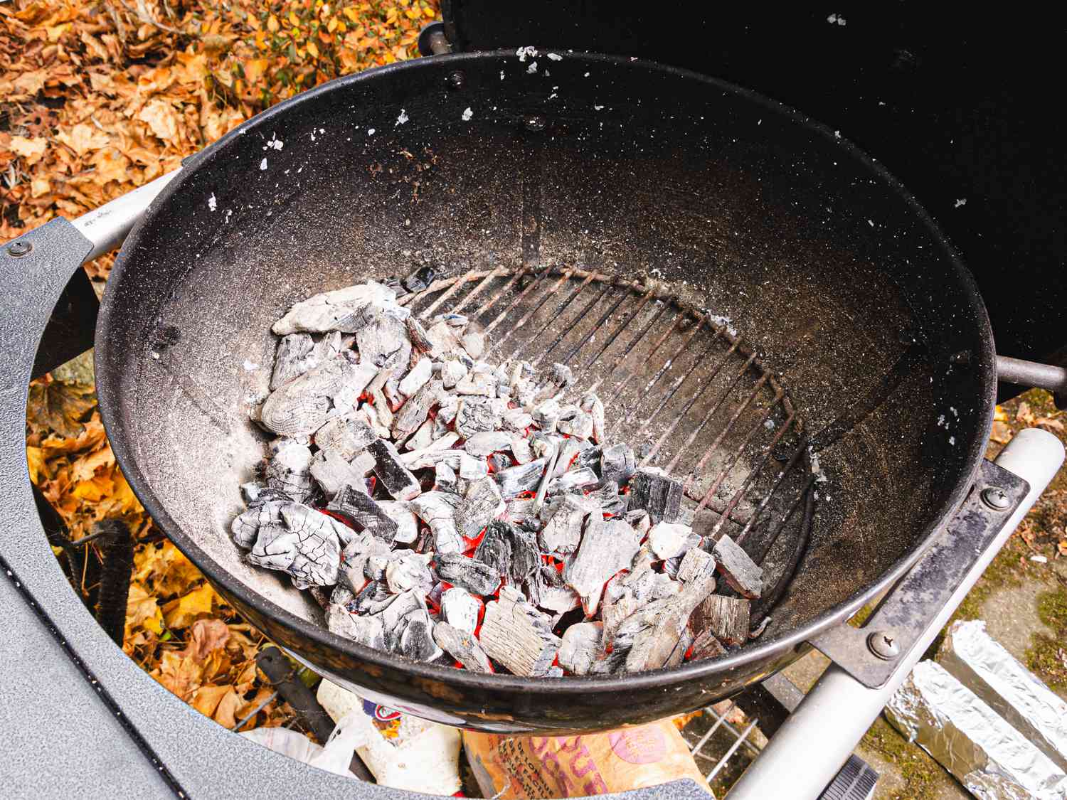 Overhead view of charcoal in a grilled lit to one side