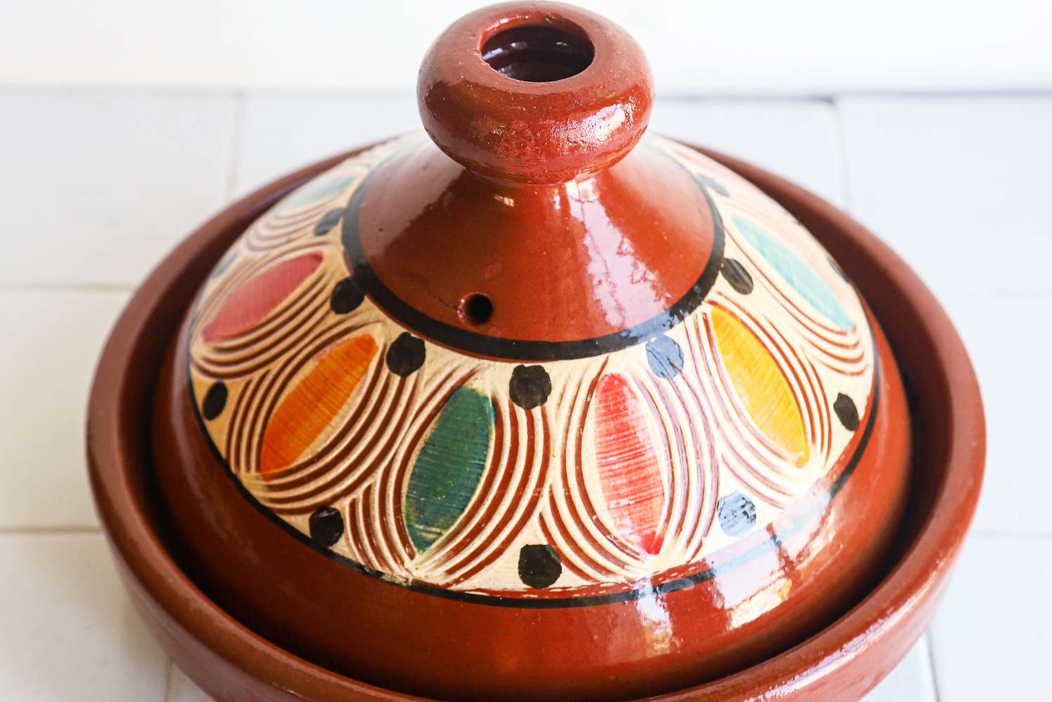 closeup image of steam hole vent on colorful tagine