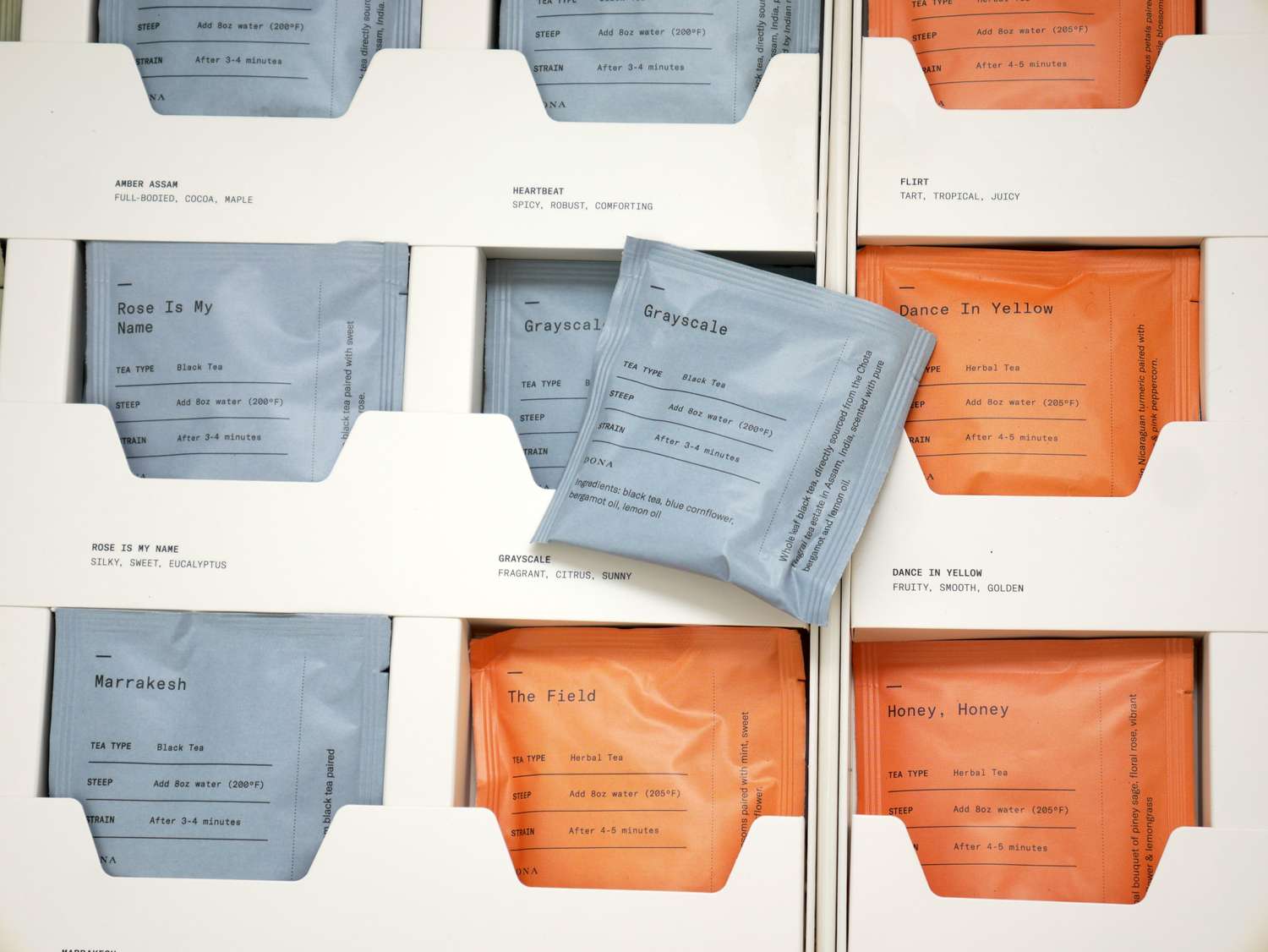 Packets of tea neatly arranged in compartments with labels indicating various types of tea blends