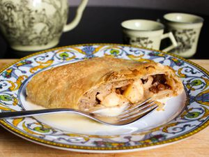 Apple strudel on a plate with a fork. 