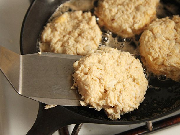 A spatula lifting a crab cake with little binder which easily falls apart. 