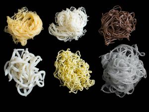 Six different Asian noodle types on a black background