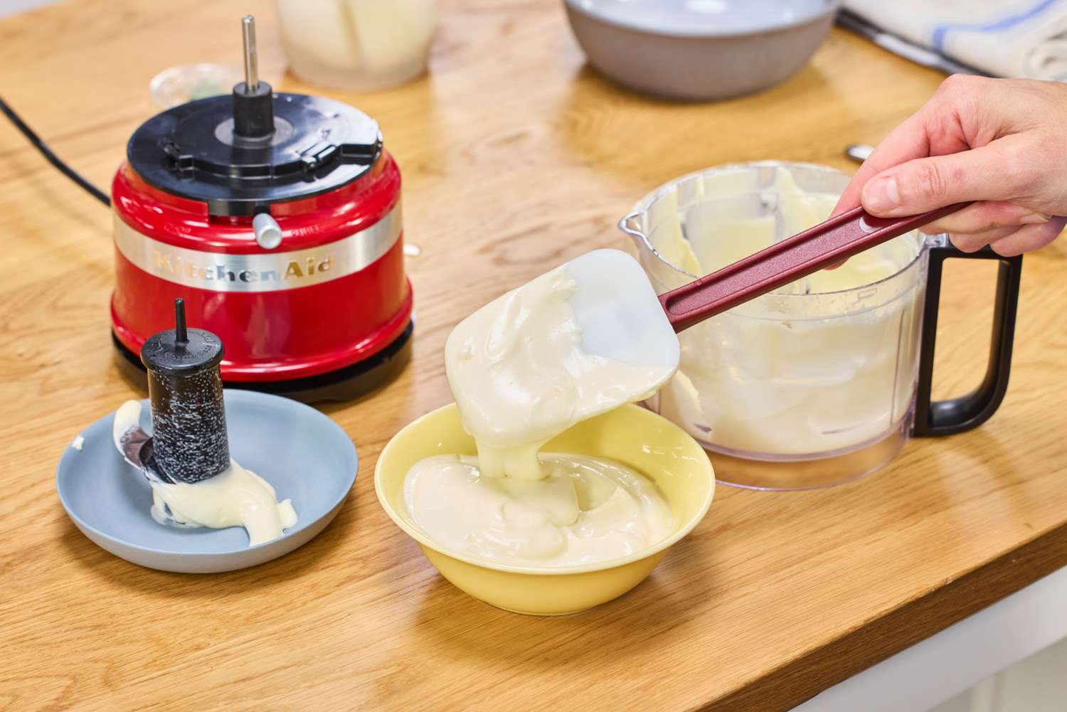 White sauce made in the KitchenAid 3.5-Cup Food Chopper is spooned into a bowl