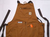 the carhartt apron on a white tile surface