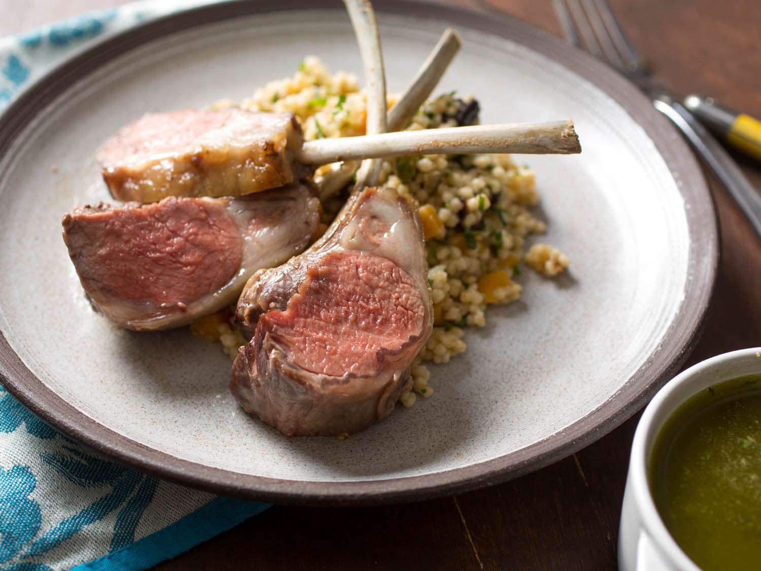 A plate of lamb chops from a crown roast of lamb, with couscous stuffing.