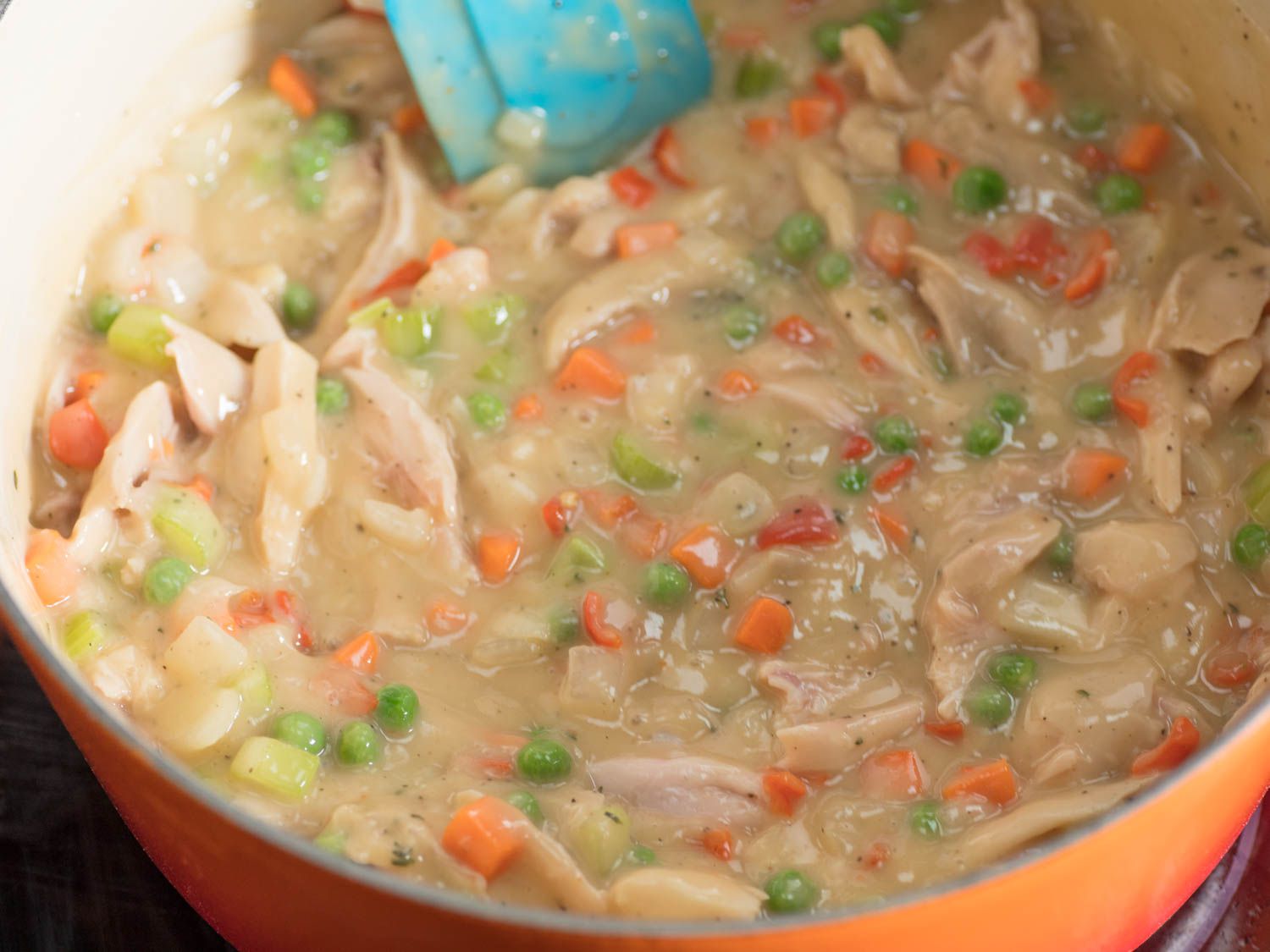 Filling for chicken pot pies in a Dutch oven. 