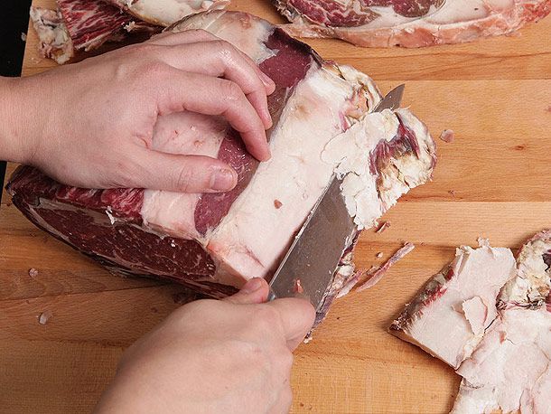 Trimming fat off a dry-aged cut of beef.