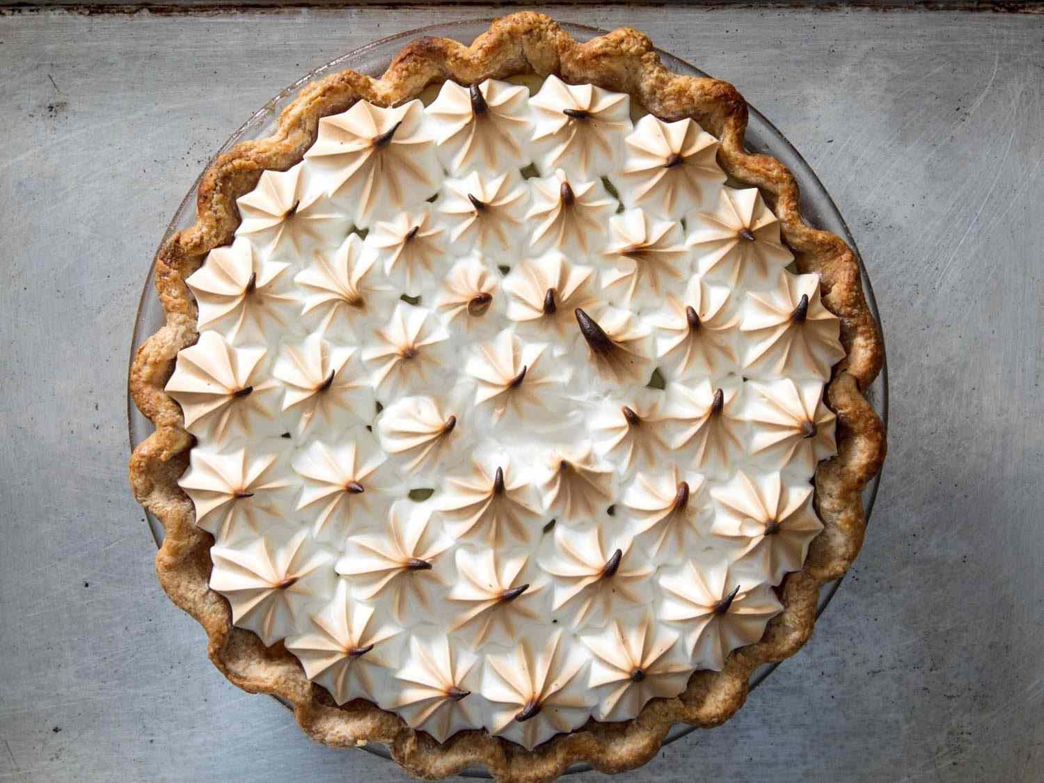 Overhead view of the finished pie. The tops of the piped meringue are singed from the heat of the oven.