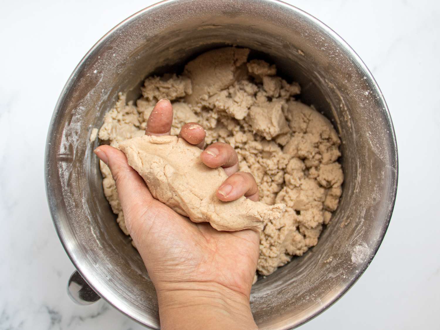 Crumb topping compressed into chunks together by hand