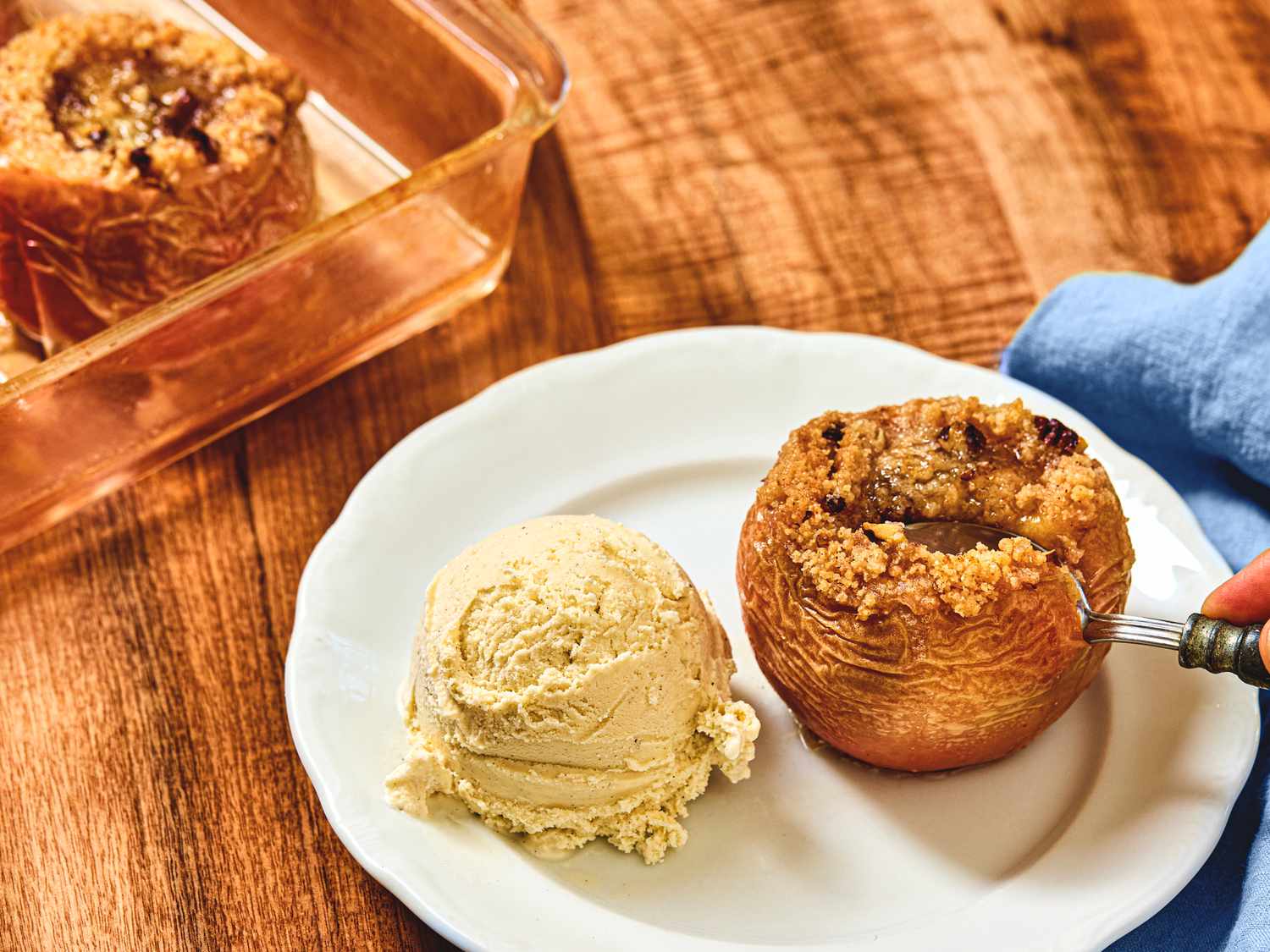 Baked apple served with a scoop of ice cream on a plate dessert prepared for serving