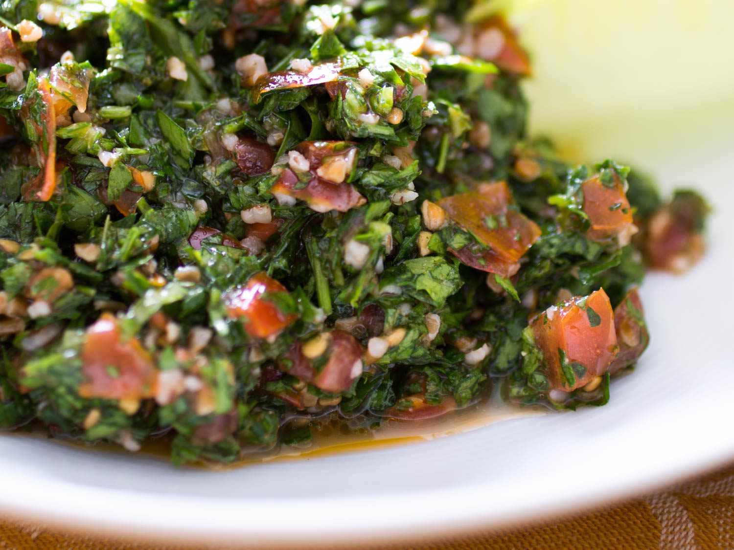 Closeup of tabbouleh with excess moisture.