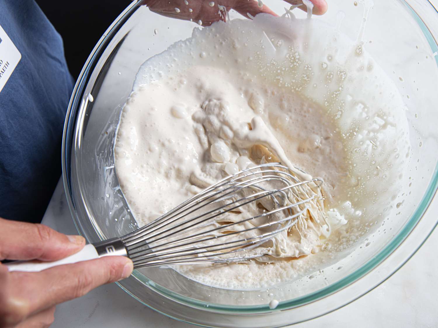 Whipped cream being mixed in a bowl