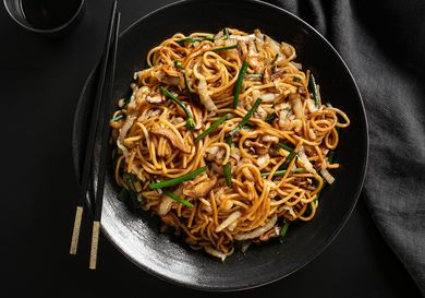 a bowl of Stir-Fried Lo Mein with Charred Cabbage, Shiitake Mushrooms, and Chives