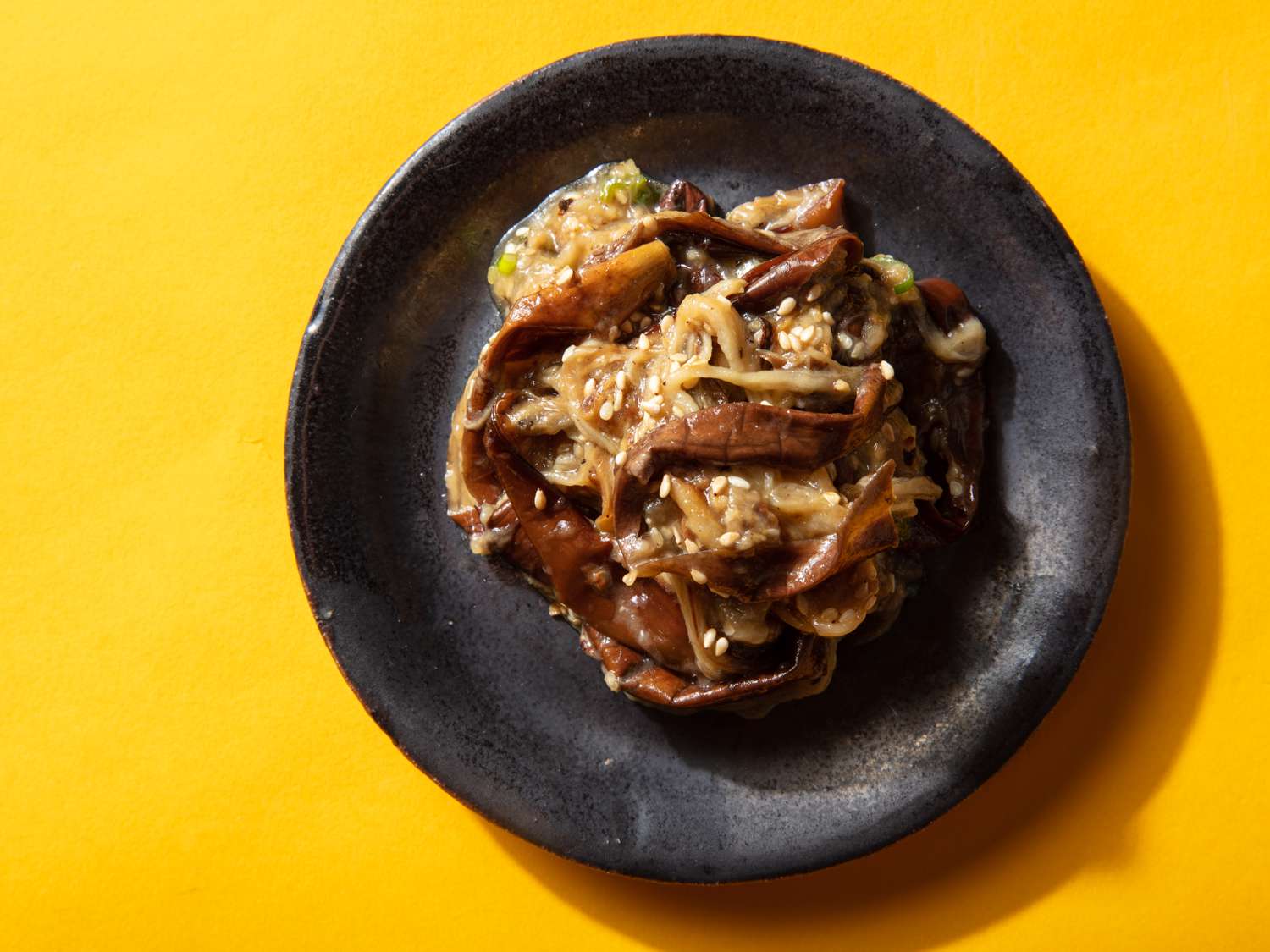 Overhead of a small plate of marinated eggplant banchan