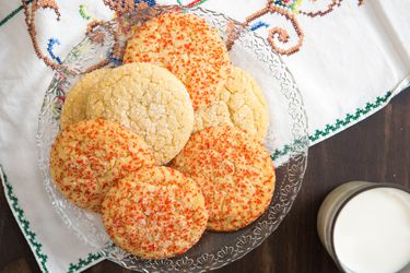 Overhead of a plate of soft and chewy sugar cookies on a glass plate
