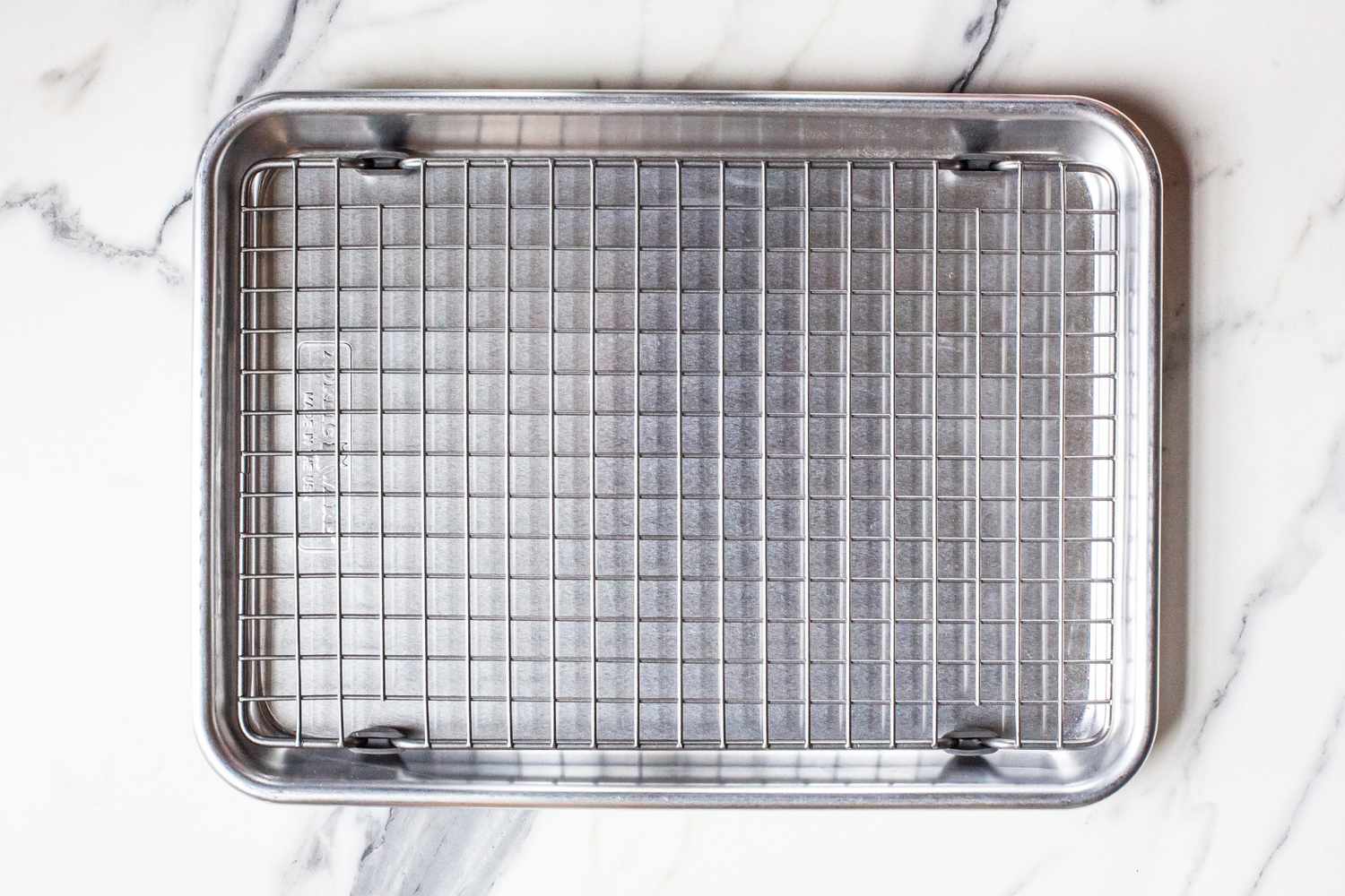 The Nordic Ware Naturals Quarter Sheet with Oven-Safe Nonstick Grid on a kitchen counter