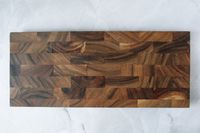 An overhead view of the Ironwood Bowery End-Grain Board on a marble background.
