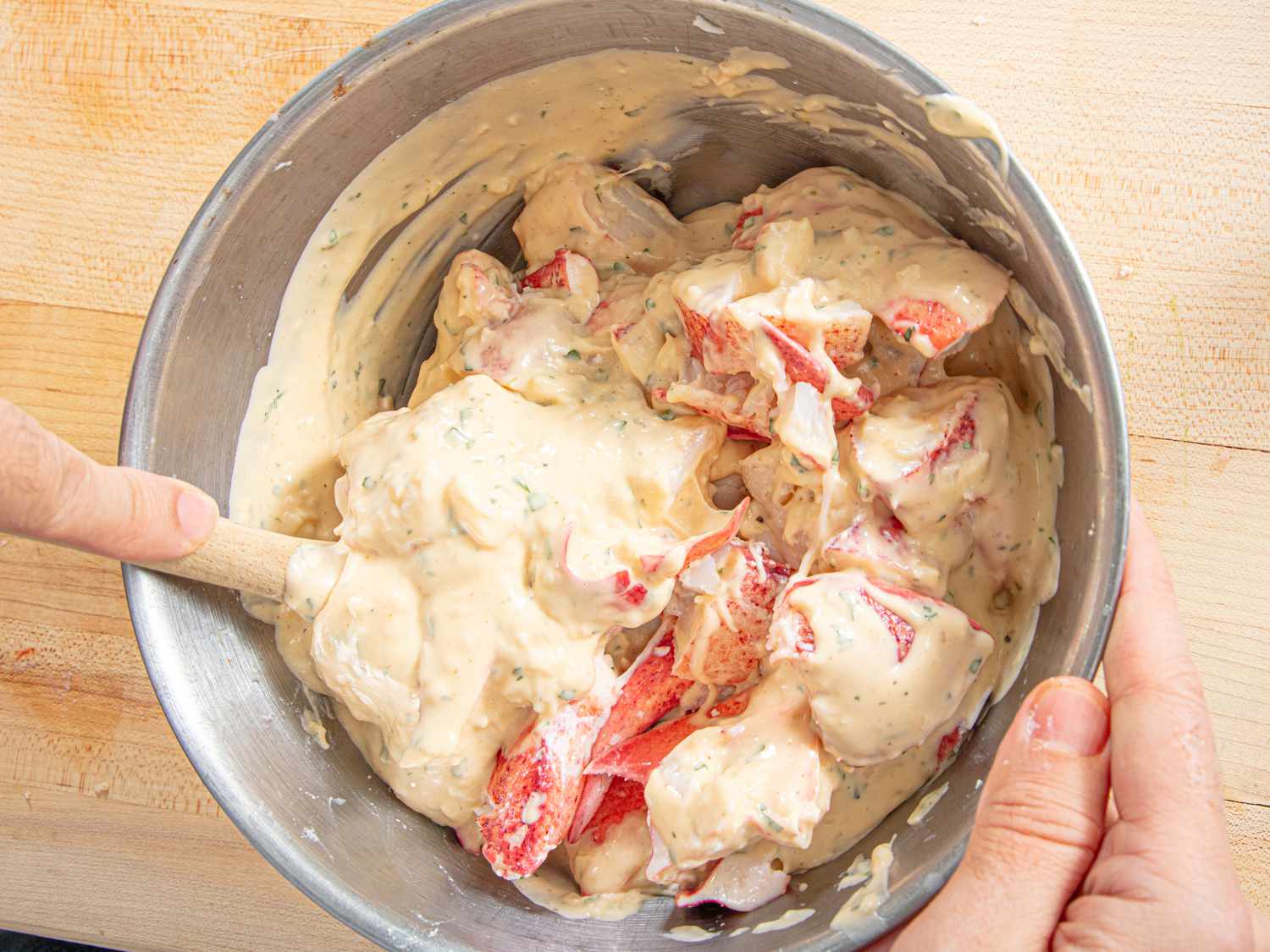 Overhead view of adding sauce to lobster