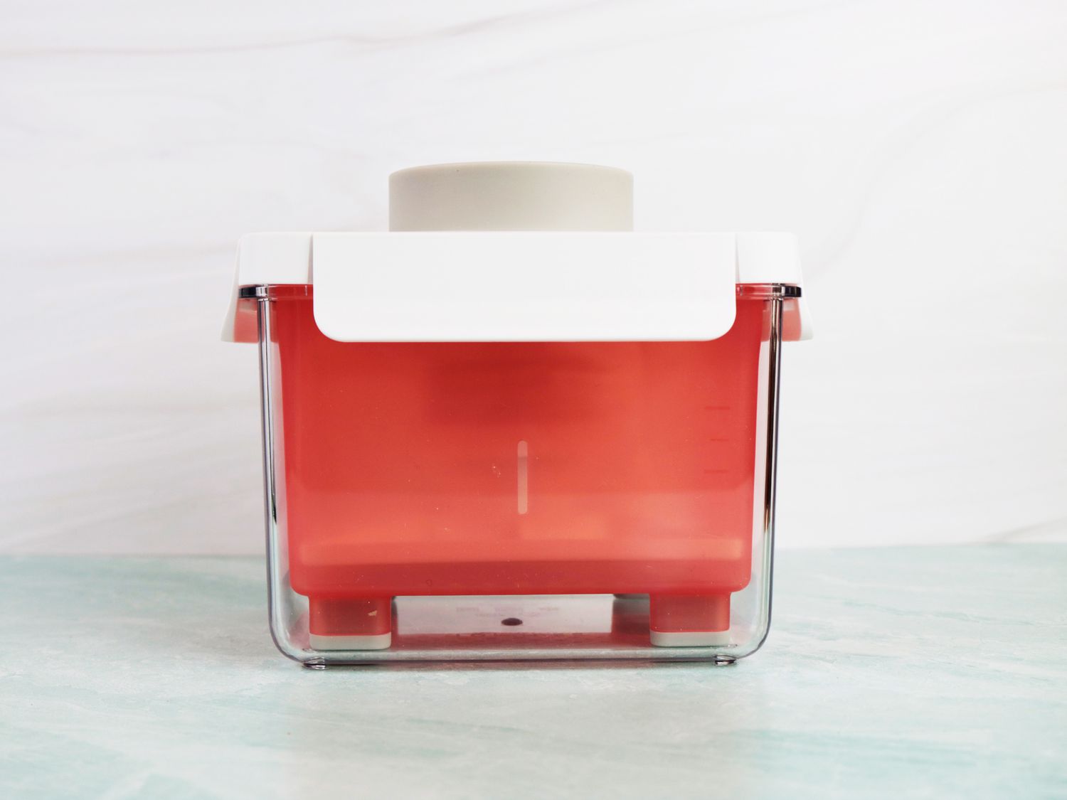 a tofu press with a dry block of tofu in it