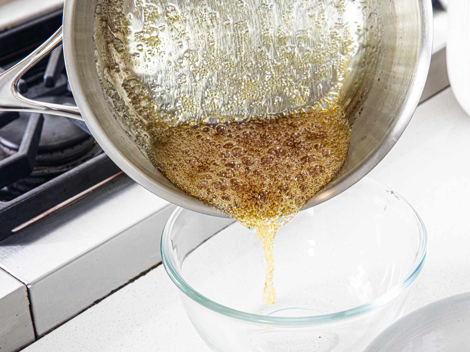 Pouring carmel into a glass bowl