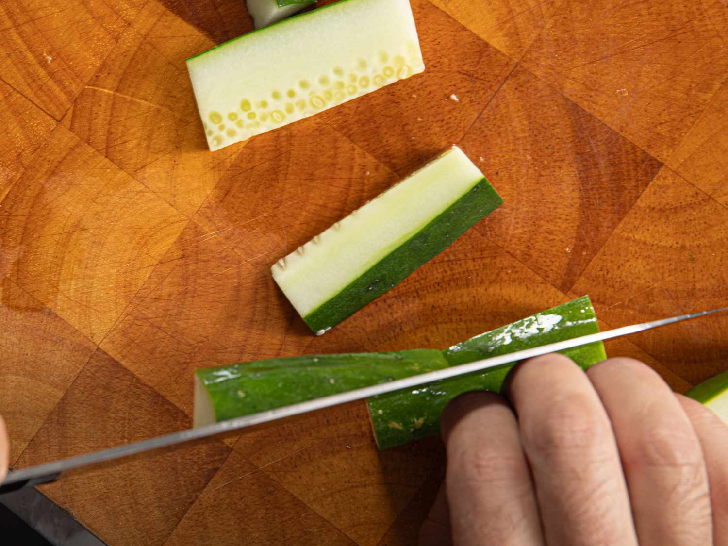Overhead view of cutting cucumber sticks