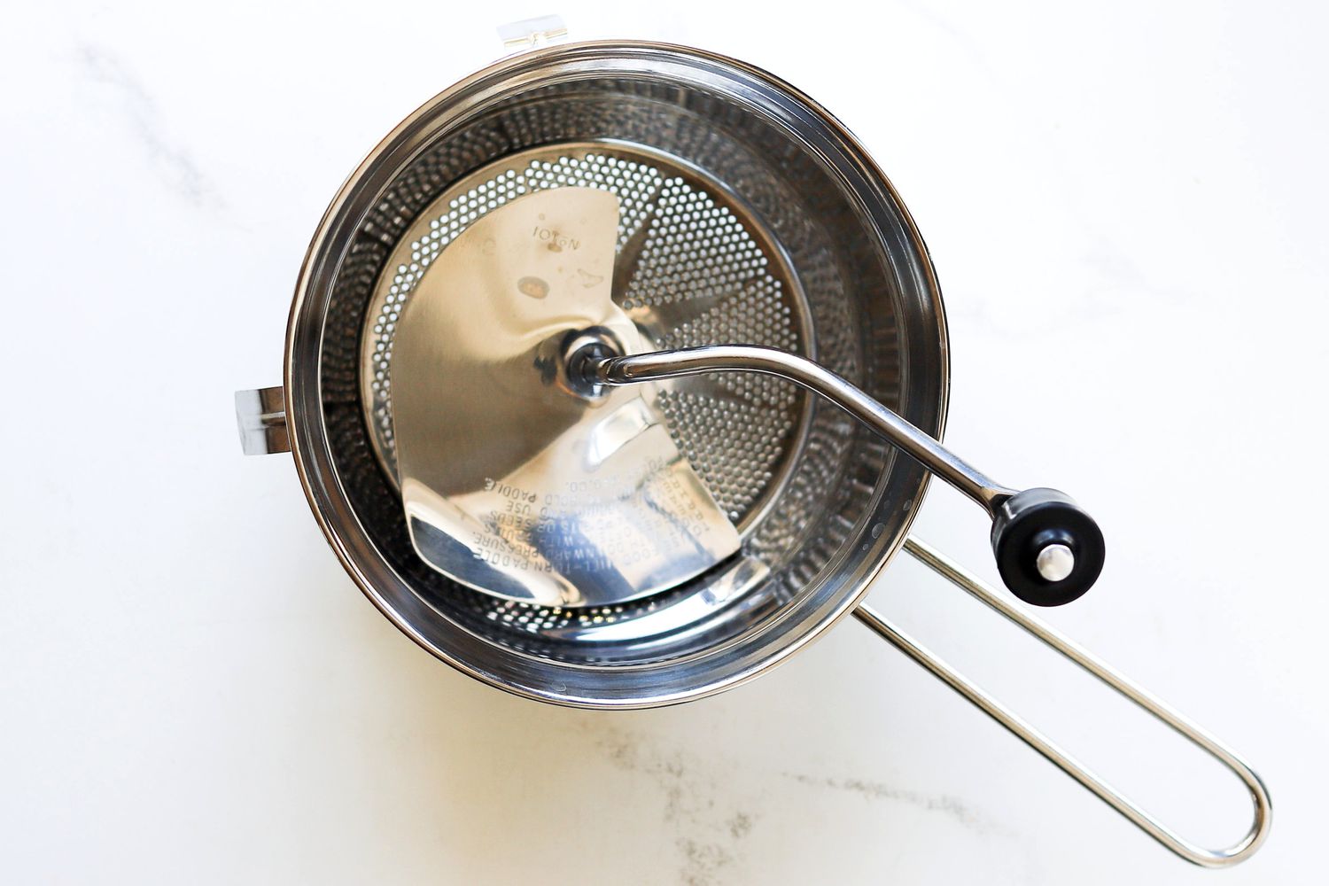 an overhead view of the mirro food mill on a marble surface