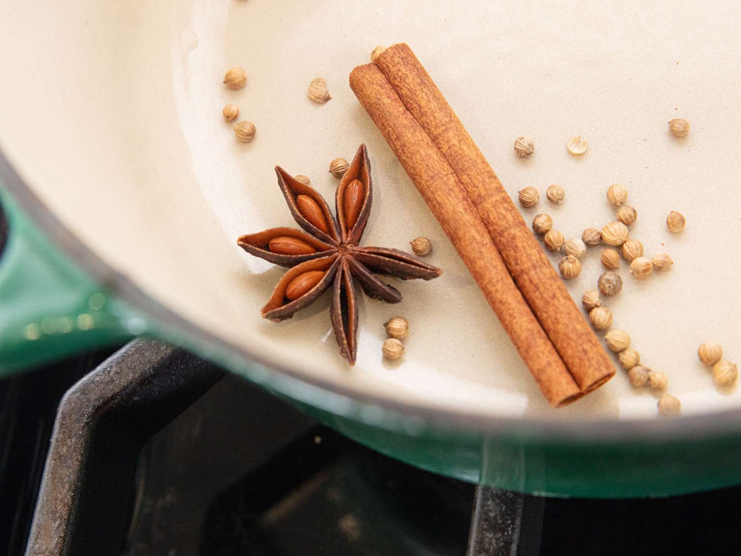 Star anice, cinnamon, and spices in a dutch oven 
