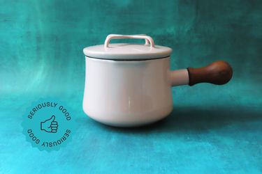 a butter warmer on a blue surface