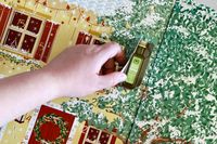 A hand opening one of the doors of the Oliviers & Co Advent Calendar