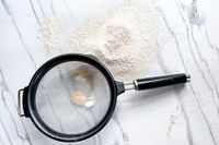 KitchenAid Classic Strainer with flour and a marble surface background showing baking preparation tools and materials