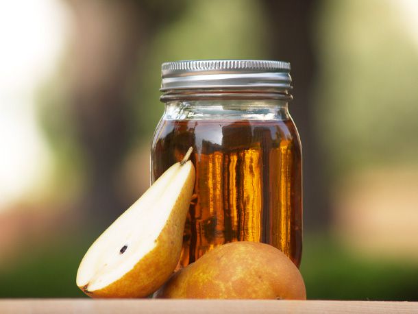 A mason jar of DIY pear liqueur.
